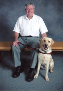 George sitting next to his dog Kroner